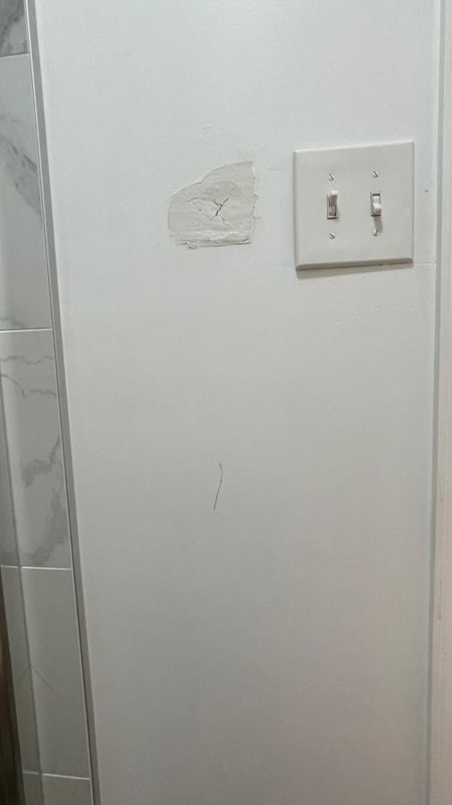 Damaged bathroom wall